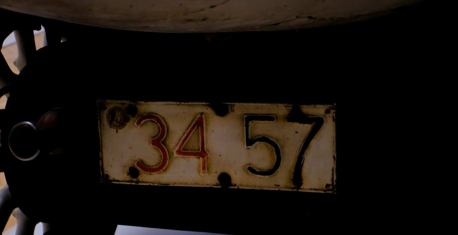 An old license plate displays the numbers 34.57.