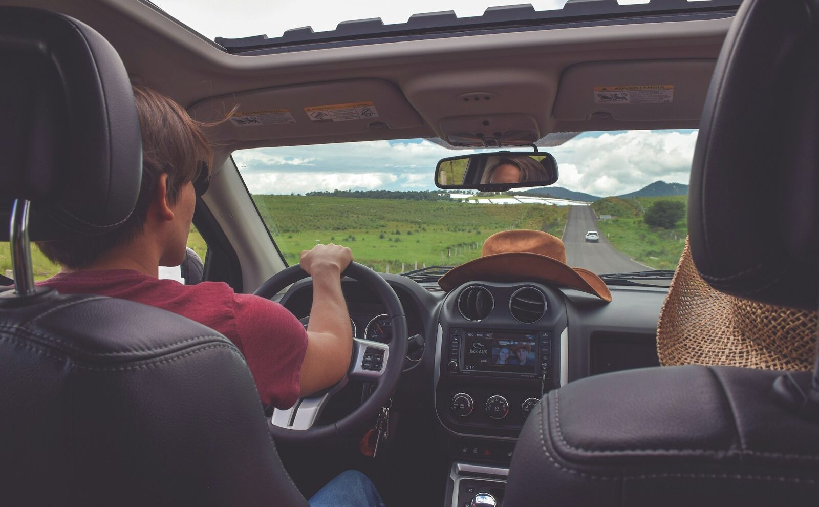 man driving straight on pathway during day time