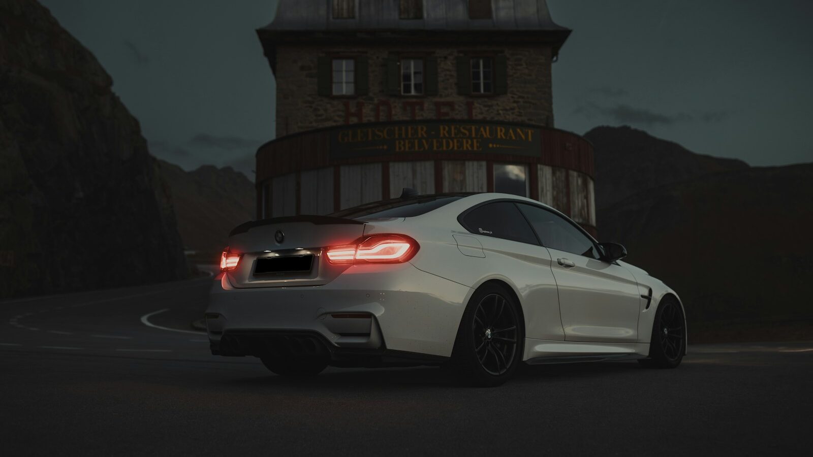 a white car parked in front of a building