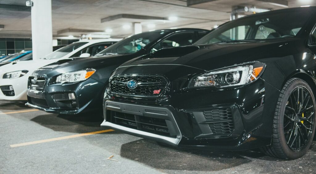 black bmw car parked on parking lot during daytime