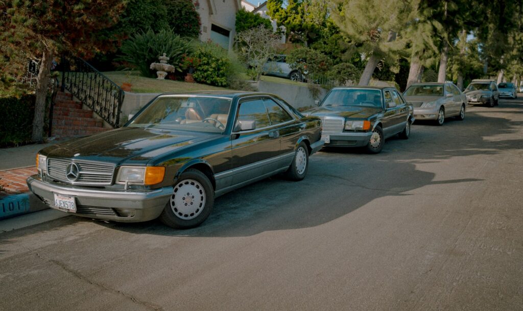 A line of cars parked on the side of a road